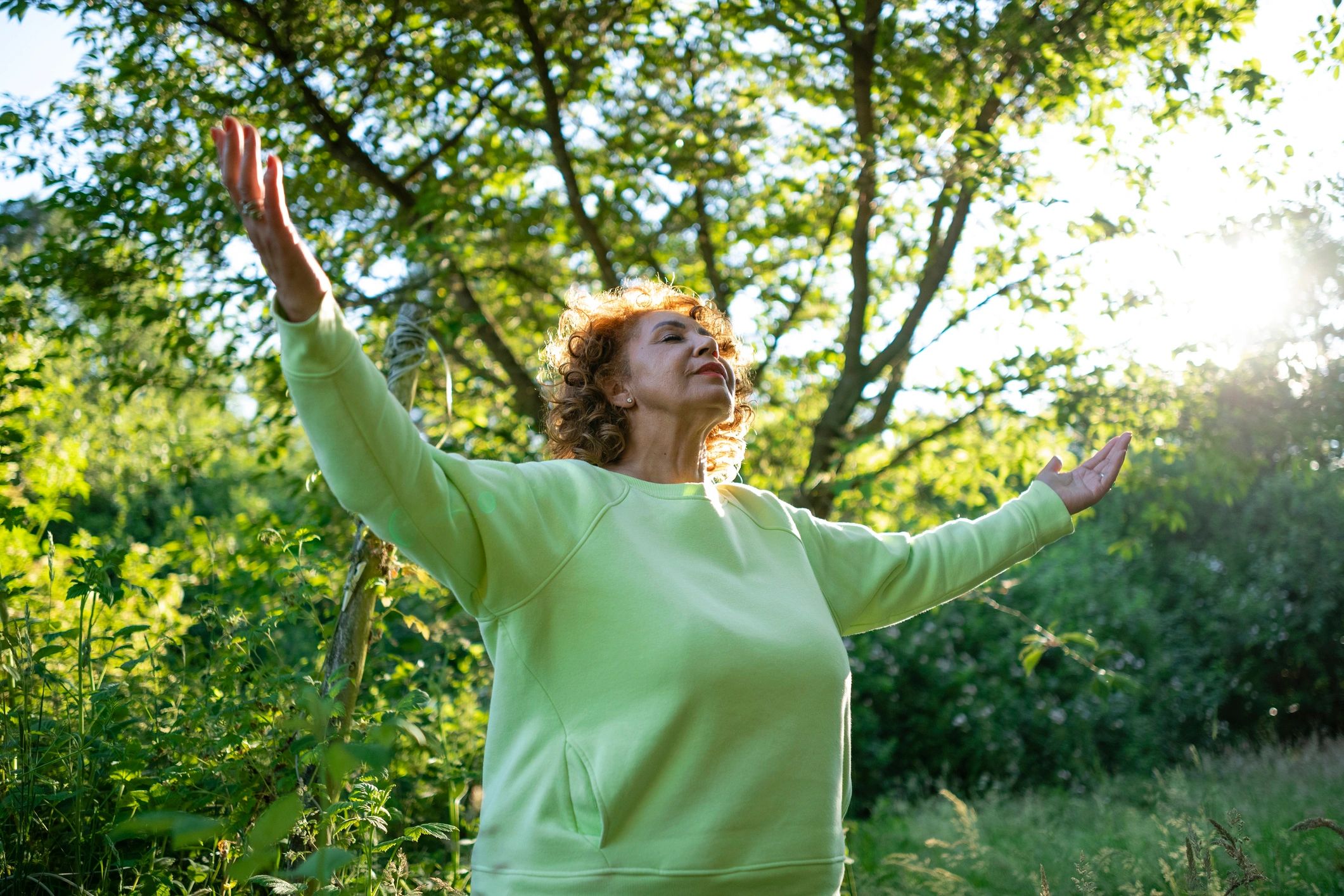 Woman outdoors in a reflective wellness moment