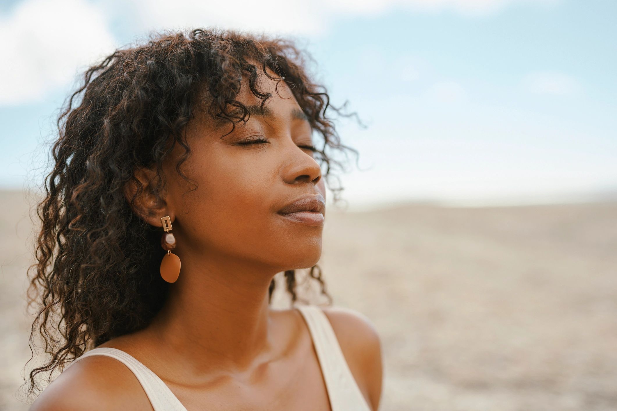 Serene woman outdoors reflecting calm, healing, and whole-person mental wellness care
