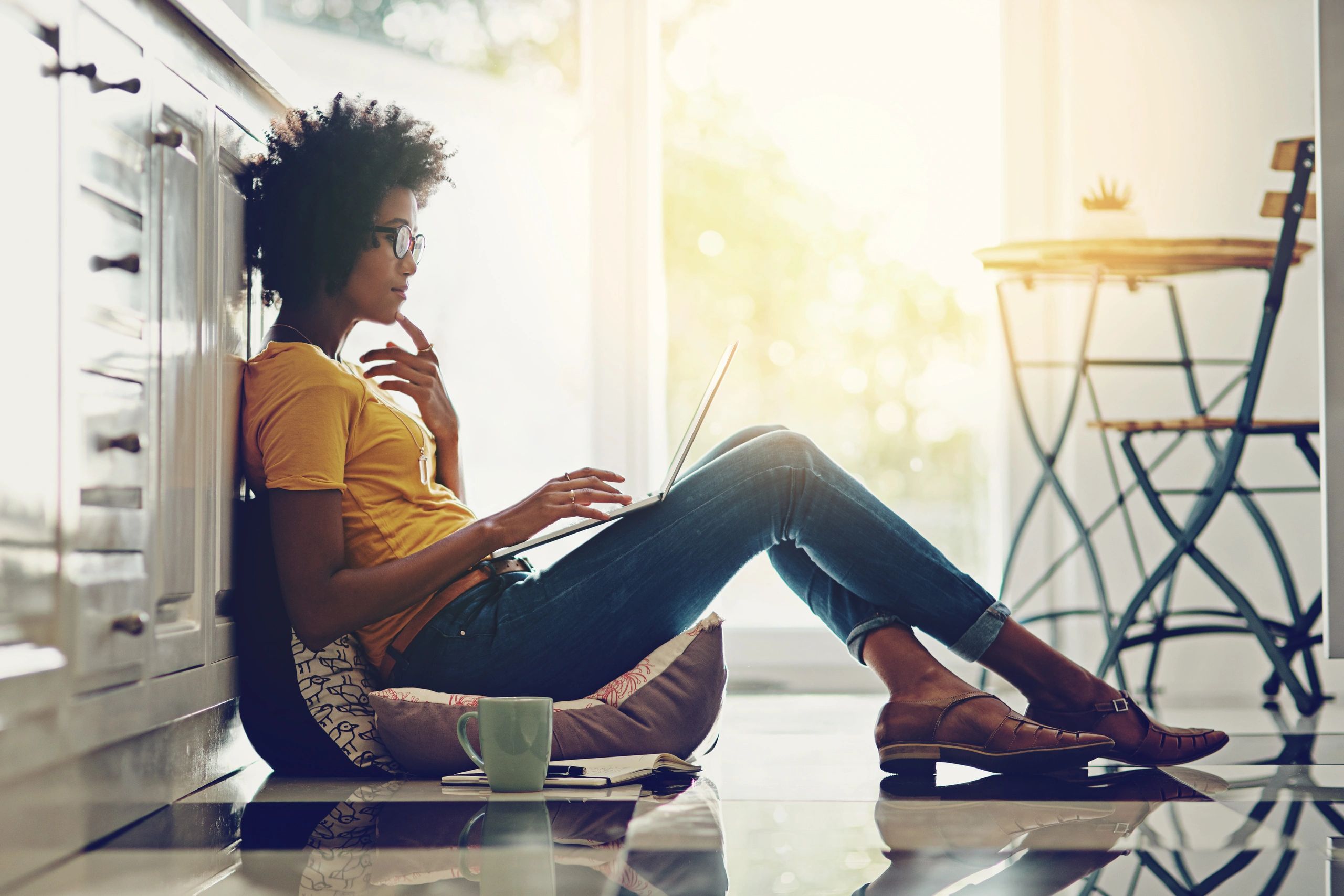 Woman relaxing at home while using a laptop
